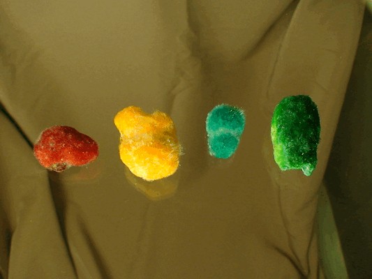 The result of the following photo, each of these okenite clusters have been colored by food coloring.