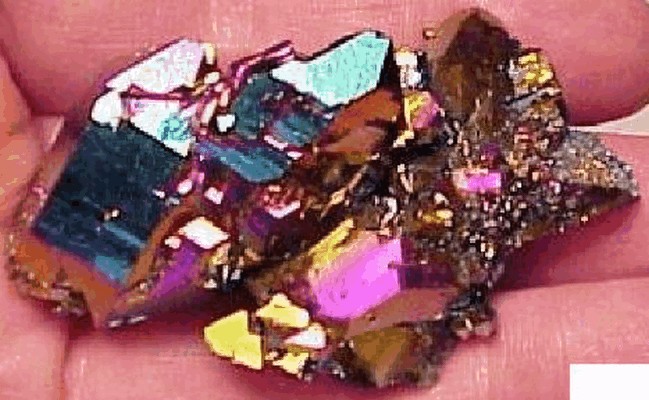 Titanium, the same element that makes white paint, produces a wild colorful apperance with quartz